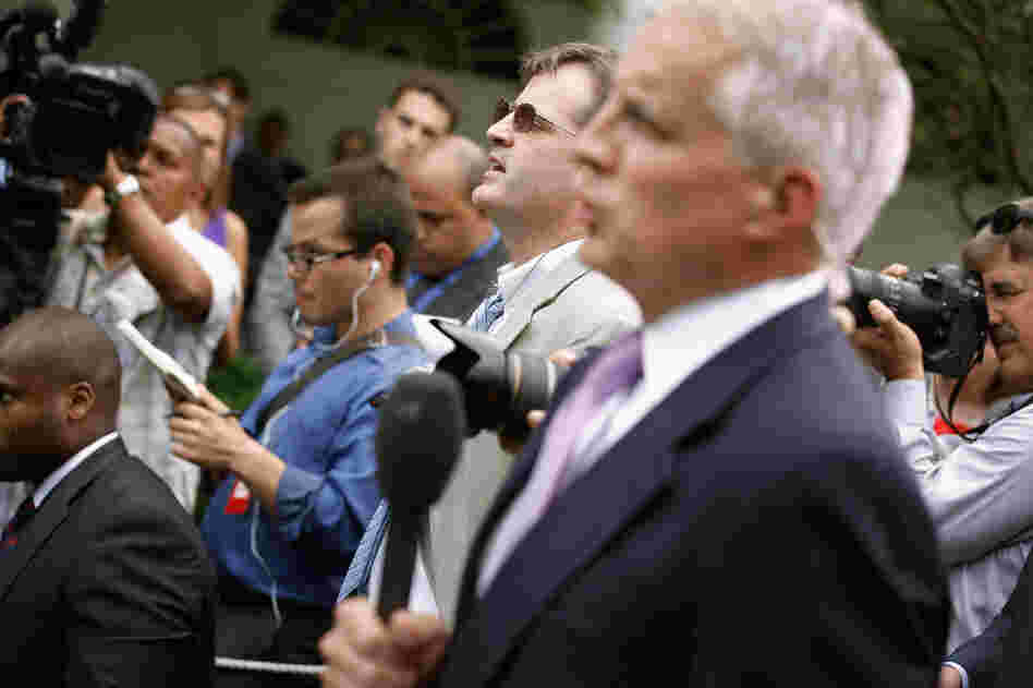 Neil Munro of the Daily Caller (center) interrupts U.S. President Barack Obama with questions as he delivered remarks in the Rose Garden at the White House.