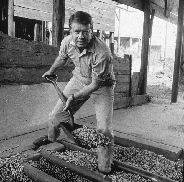 Jimmy Carter shovels peanuts in an image from the 1970s.