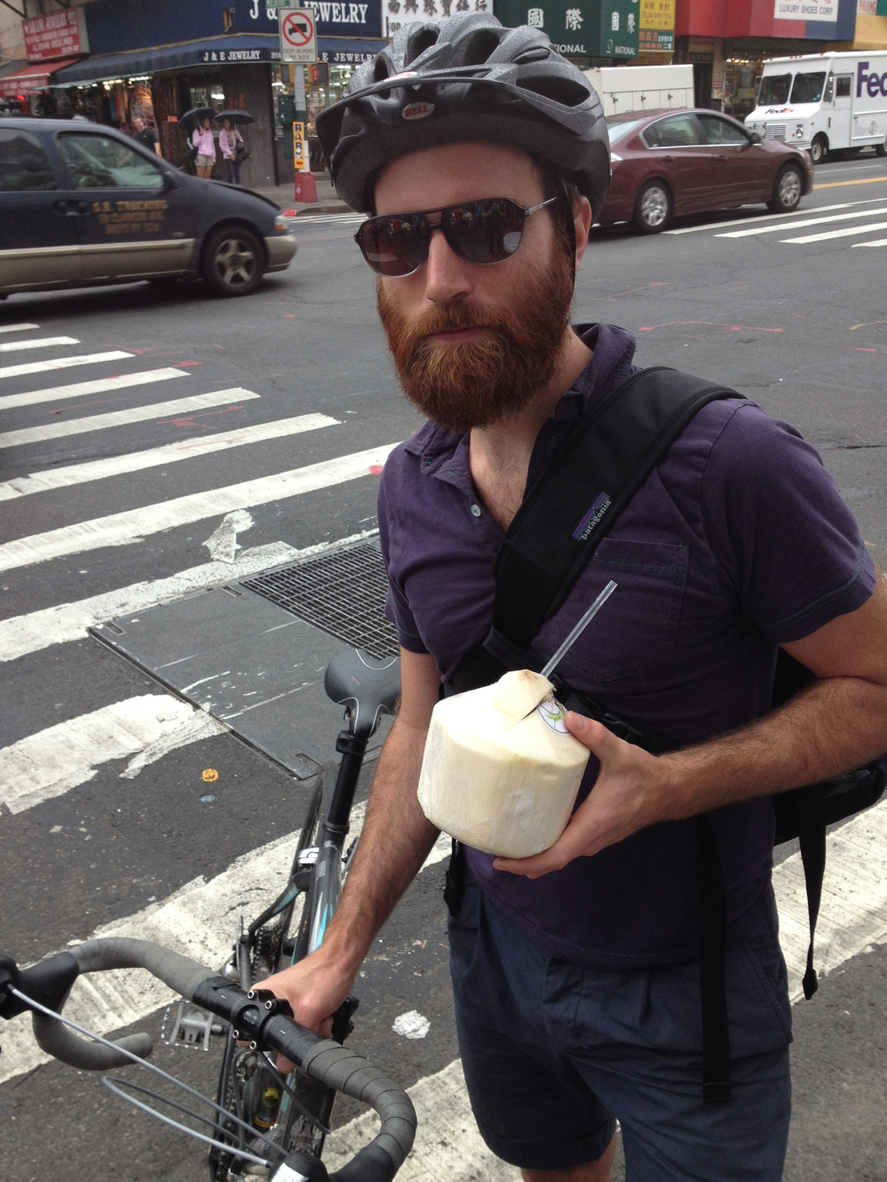 John Gordon Gauld, a 35-year old artist, bikes with coconut water in New York City.