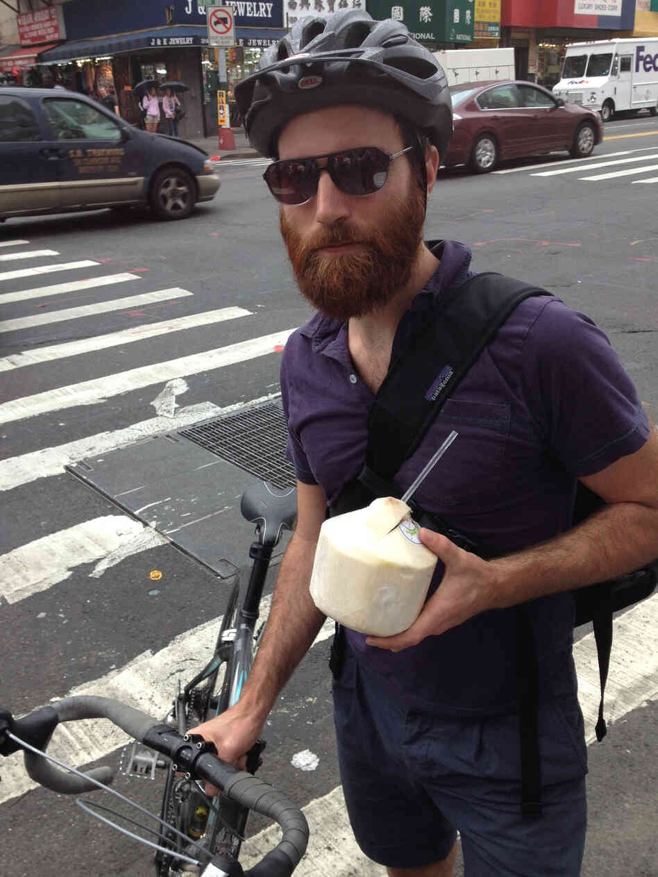 John Gordon Gauld, a 35-year old artist, bikes with coconut water in New York City.