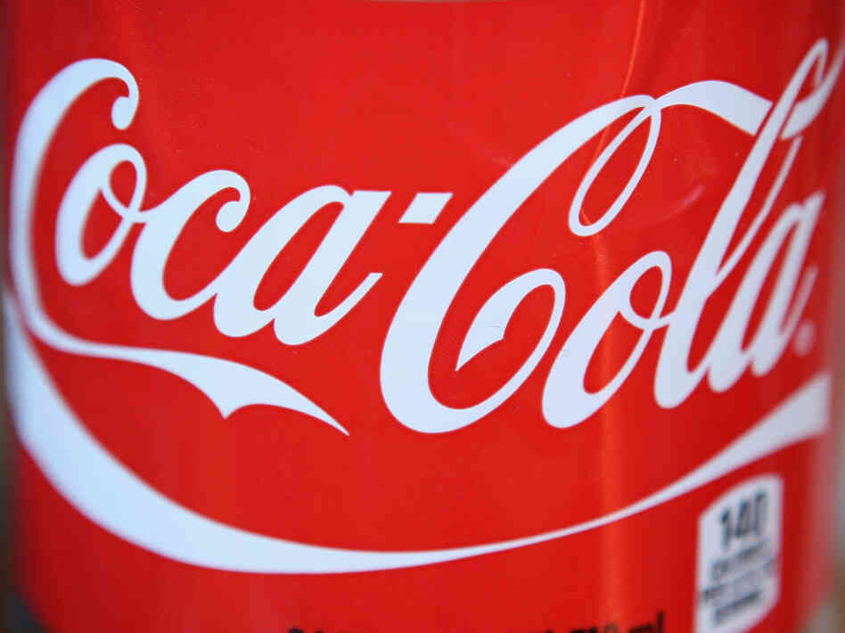 The Coca-Cola logo on a 24-ounce bottle.