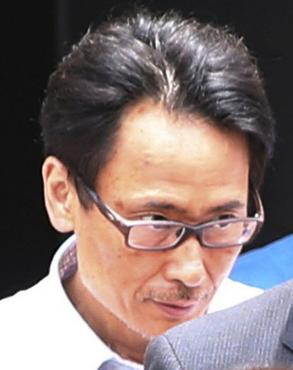 Katsuya Takahashi, the last fugitive connected to the 1995 sarin attack on Tokyo's subway system, after his arrest today.