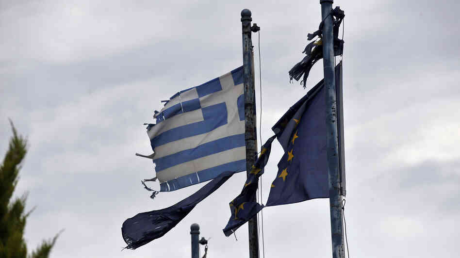 Torn Greek (left) and European Union flags fly at the entrance of an abandoned factory in the industrial zone of Komotini about 500 miles from Athens. Sunday's parliamentary election will go a long way toward determining whether Greece stays in the EU.