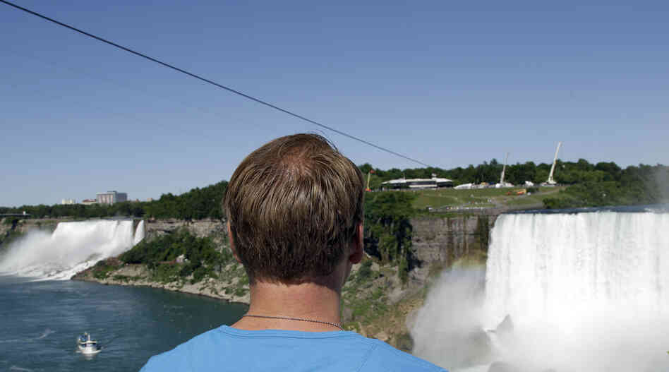 Nik Wallenda looks at the tightrope cable in Niagara Falls, Canada on Wednesday.