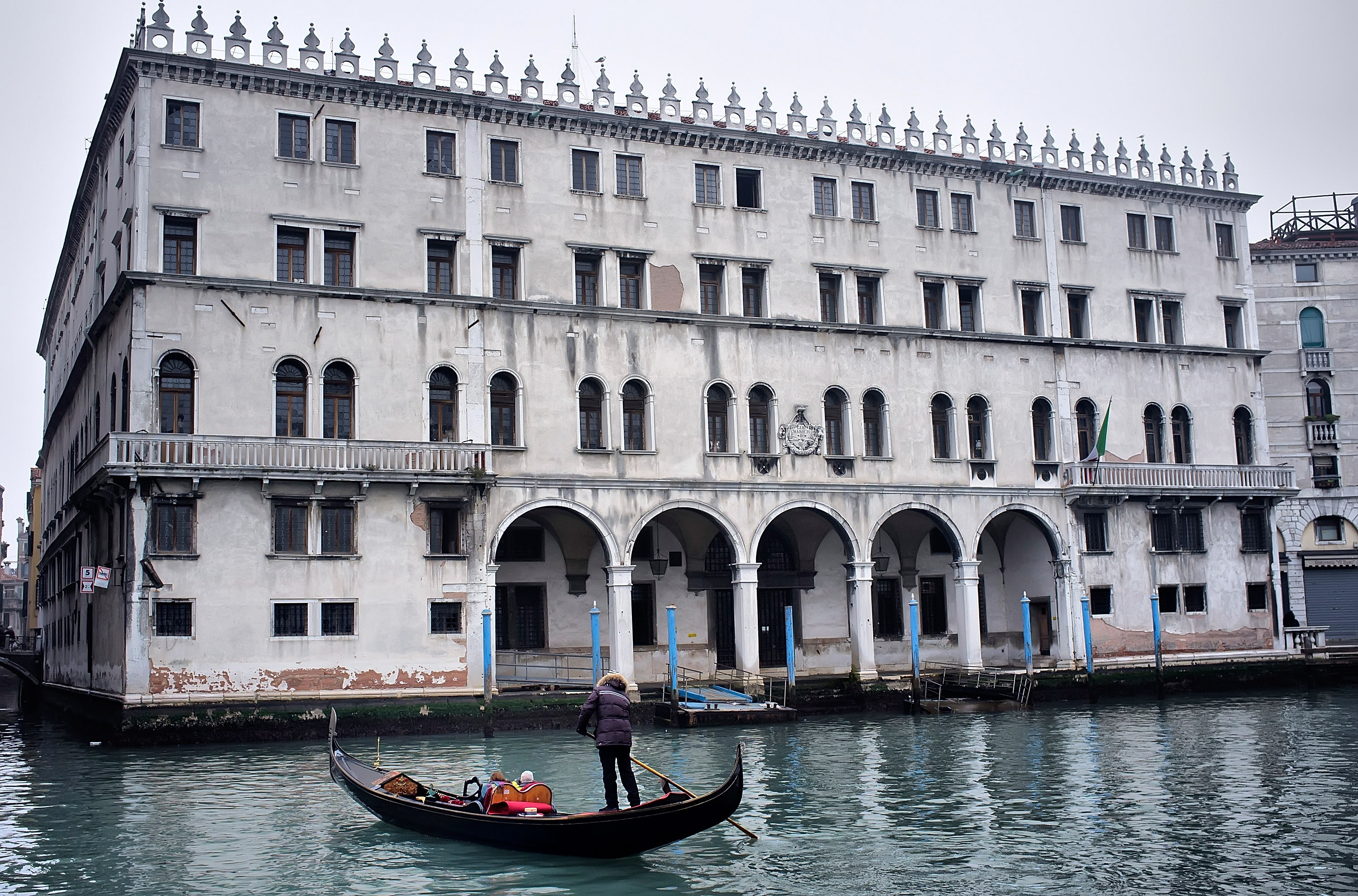 A gondola sails in front of the Fondaco dei Tedeschi, which has been sold to Benetton Group. The clothing company plans to convert the Venice landmark into a shopping mall.