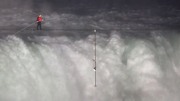 Nik Wallenda crosses over  Niagara Falls on a tightrope on Friday. He became the first person to cross directly over the falls from the U.S. into Canada.