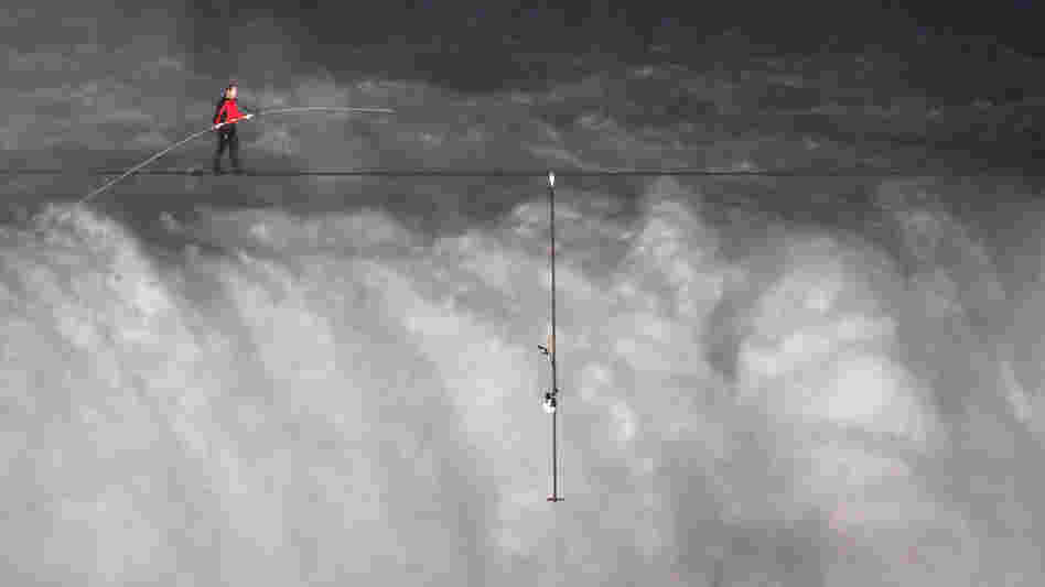 Nik Wallenda crosses over  Niagara Falls on a tightrope on Friday. He became the first person to cross directly over the falls from the U.S. into Canada.