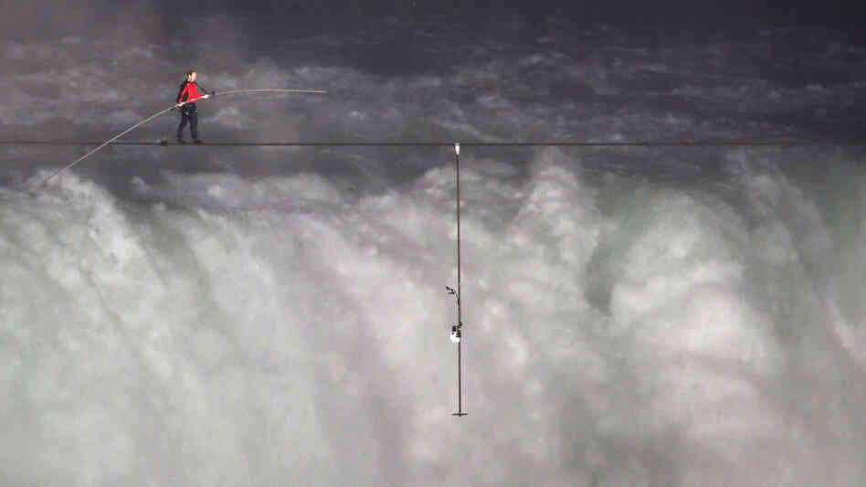 Nik Wallenda crosses over  Niagara Falls on a tightrope on Friday. He became the first person to cross directly over the falls from the U.S. into Canada.