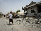 Yemeni residents walk past vehicles and houses which were destroyed during recent fighting between the army and militants on a road leading to the city of Zinjibar on Thursday. Yemeni residents walk past vehicles and houses which were destroyed during recent fighting between the army and militants on a road leading to the city of Zinjibar on Thursday.