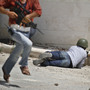 A Free Syrian Army fighter fires his weapon during clashes with Syrian troops near Idlib, Syria, on Friday. The U.N. said Saturday it is suspending its mission in Syria because of escalating violence.