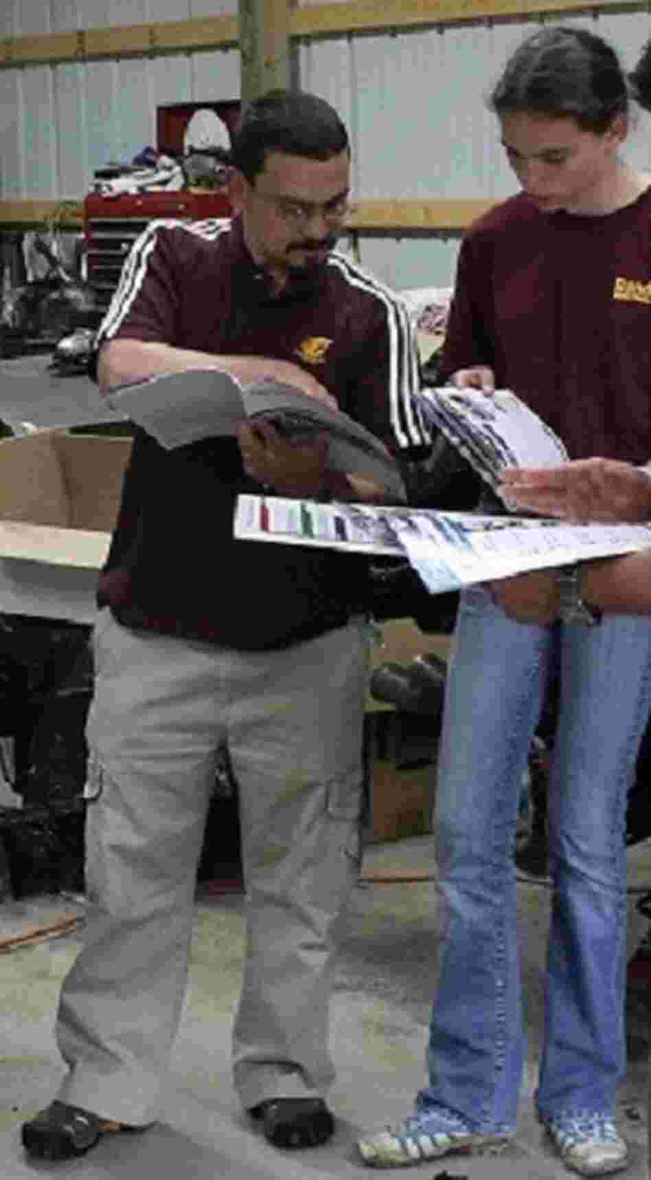 Jerry DiMaria and his daughter, Kathryn, look through Pontiac Fiero catalogs. Jerry DiMaria and his daughter, Kathryn, look through Pontiac Fiero catalogs.