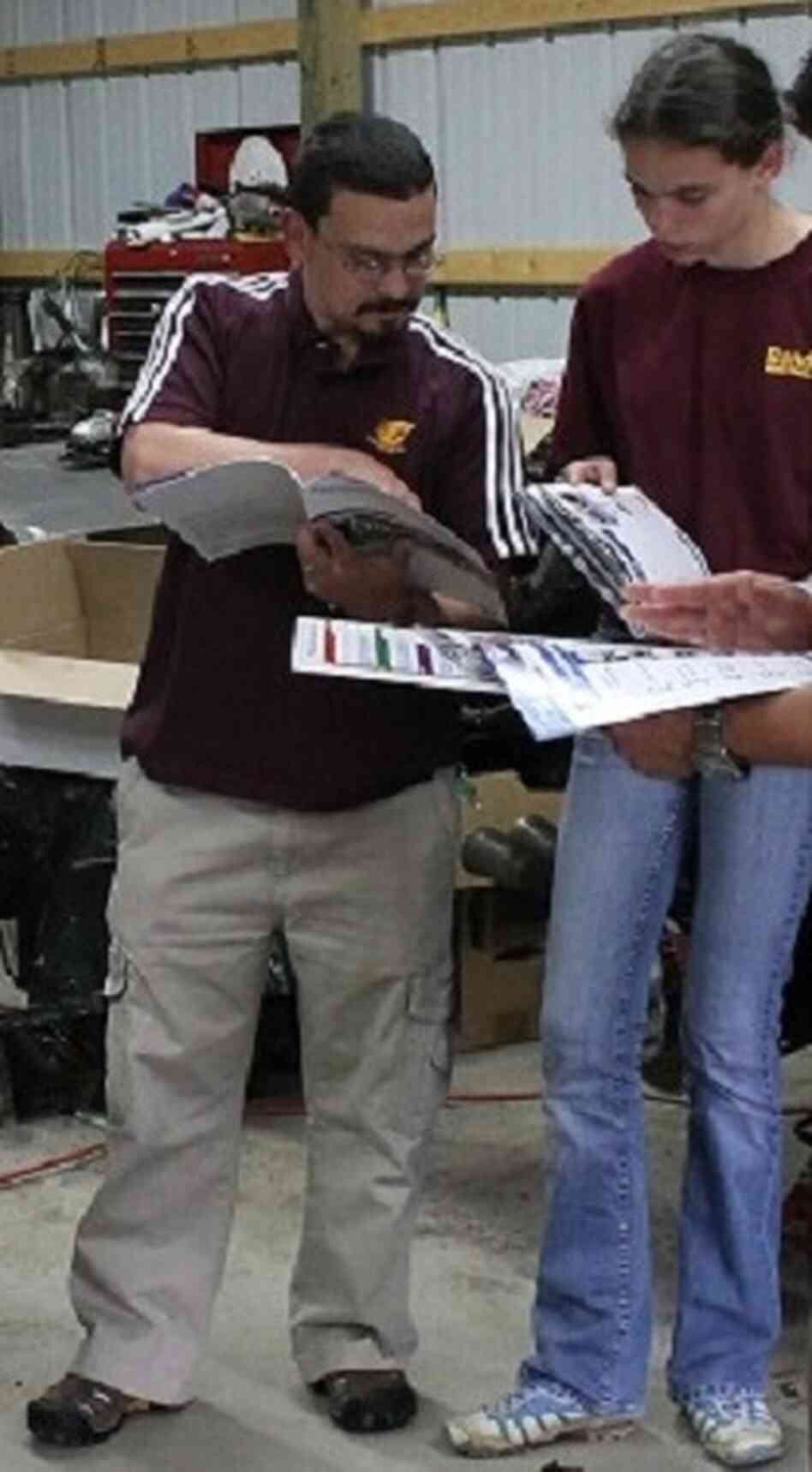 Jerry DiMaria and his daughter, Kathryn, look through Pontiac Fiero catalogs. Jerry DiMaria and his daughter, Kathryn, look through Pontiac Fiero catalogs.