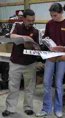 Jerry DiMaria and his daughter, Kathryn, look through Pontiac Fiero catalogs. Jerry DiMaria and his daughter, Kathryn, look through Pontiac Fiero catalogs.
