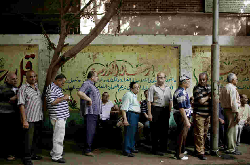 Egyptian men line up to vote at a polling station in the Shobra neighborhood of Cairo on Sunday.