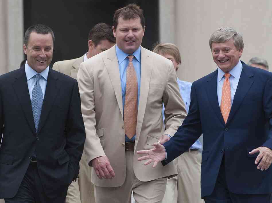 Former pitcher Roger Clemens, center, and his attorneys Rusty Hardin, right, and Michael Attanasio arrive on the courthouse steps after Clemens was found not guilty on all charges in his perjury trial at U.S. District Court in Washington, D.C., on Monday.