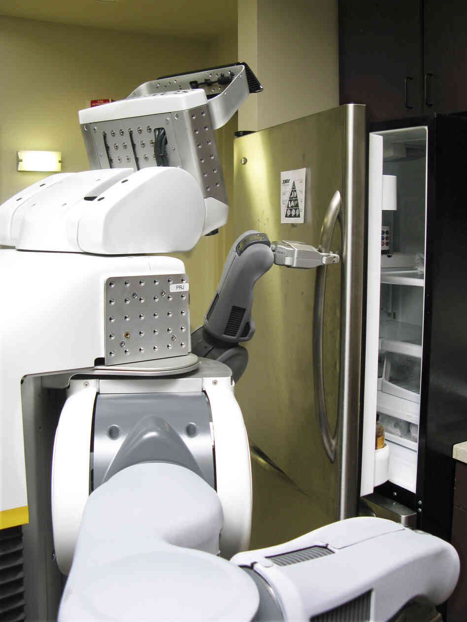 A PR2 robot named Jake opens a refrigerator at Willow Garage's office.