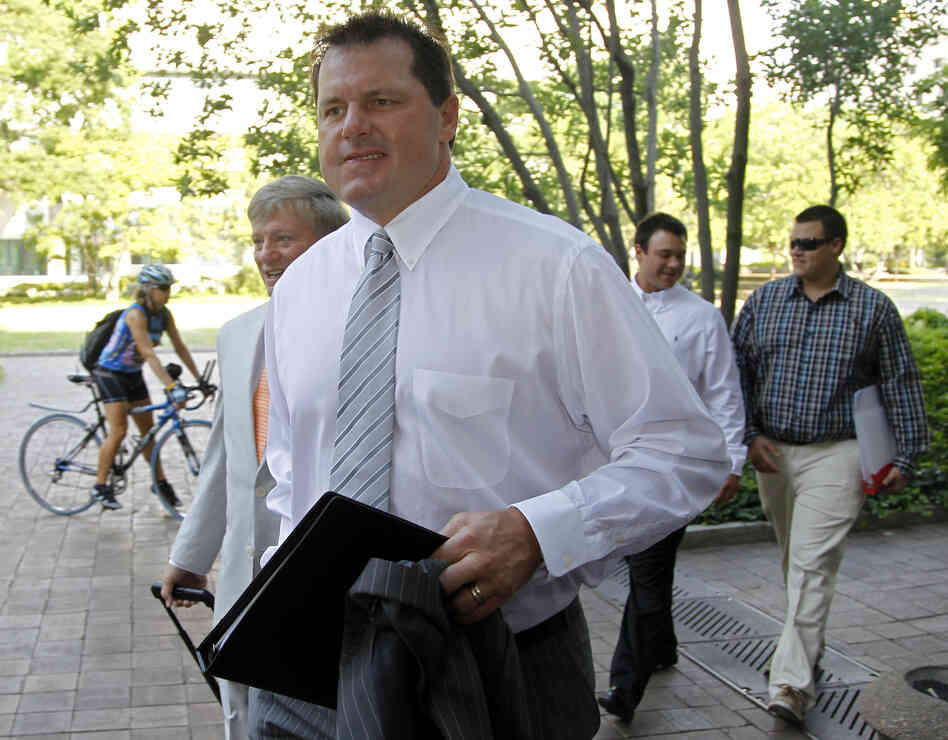 Former Major League Baseball pitcher Roger Clemens, accompanied by his attorney Rusty Hardin, left, arrives at federal court in Washington on June 11.