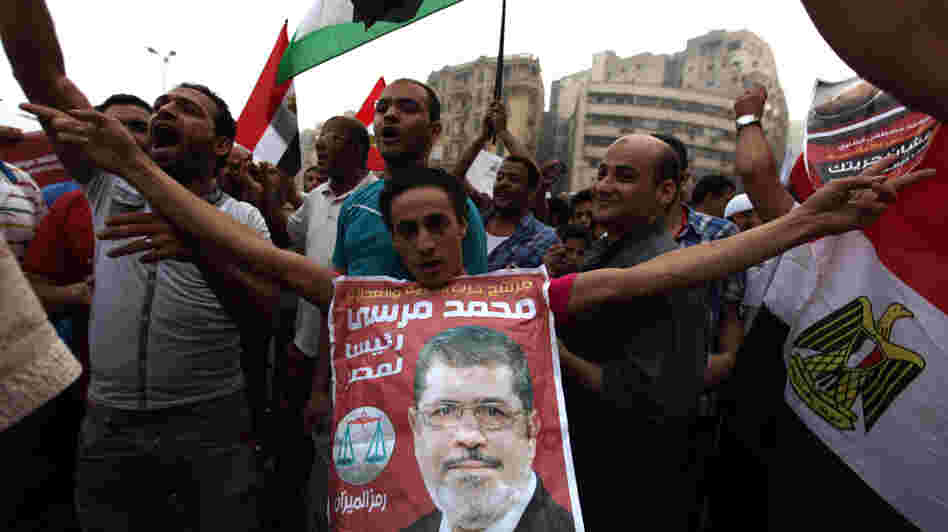 Supporters of Muslim Brotherhood candidate Mohammed Mursi (in portrait) celebrated today in Cairo's Tahrir Square.