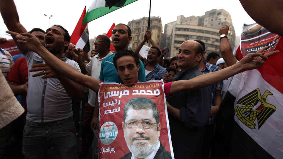 Supporters of Muslim Brotherhood candidate Mohammed Mursi (in portrait) celebrated today in Cairo's Tahrir Square.