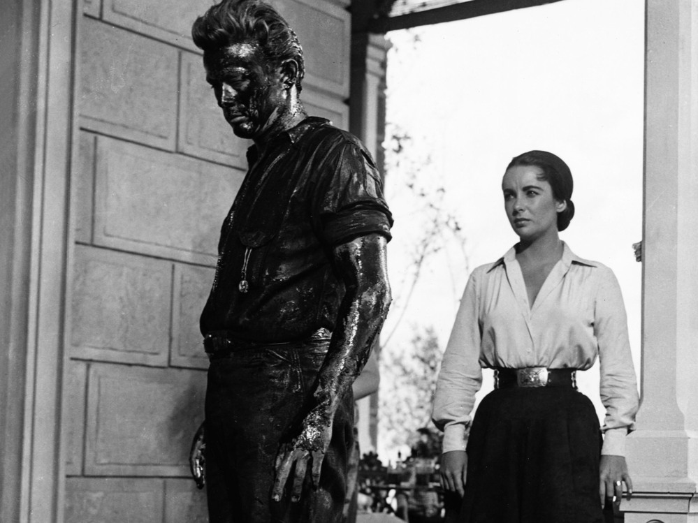 In Giant, James Dean plays Jett Rink, a poor ranch hand who strikes oil and becomes one of the richest men in Texas. Elizabeth Taylor plays Leslie Benedict, part of the wealthy ranching family that Rink feuds with.