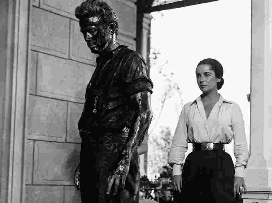 In Giant, James Dean plays Jett Rink, a poor ranch hand who strikes oil and becomes one of the richest men in Texas. Elizabeth Taylor plays Leslie Benedict, part of the wealthy ranching family that Rink feuds with.