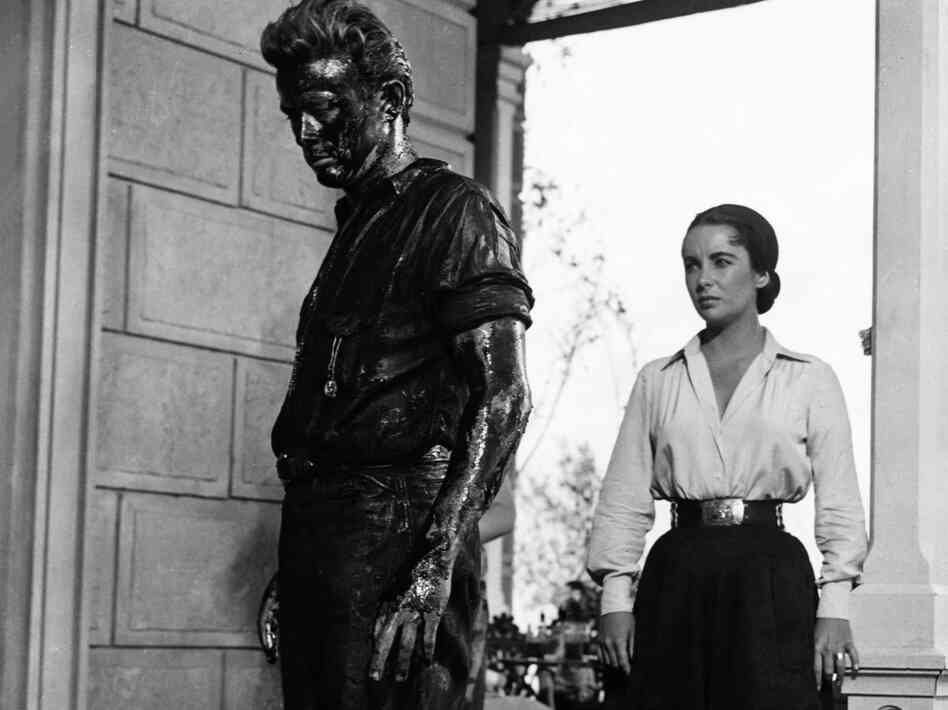 In Giant, James Dean plays Jett Rink, a poor ranch hand who strikes oil and becomes one of the richest men in Texas. Elizabeth Taylor plays Leslie Benedict, part of the wealthy ranching family that Rink feuds with.