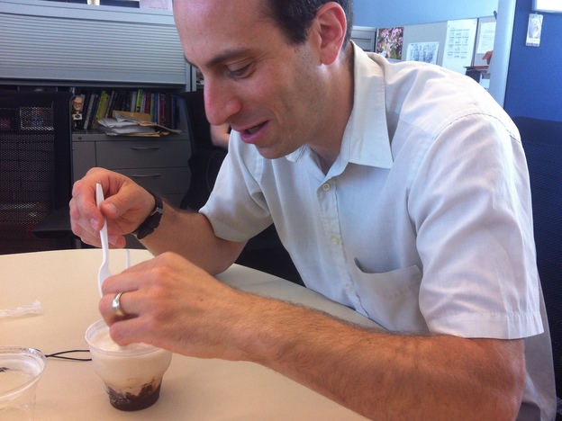 Grosz uses a spoon to defend himself from the bacon sundae.