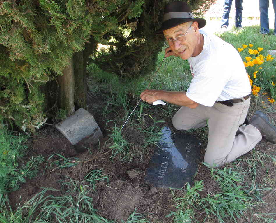 Tony Pires uses a metal rod to find a grave marker. Decades of growing plants, pecking birds and digging gophers can make things strangely "disappear" in old cemeteries like Gilliam.