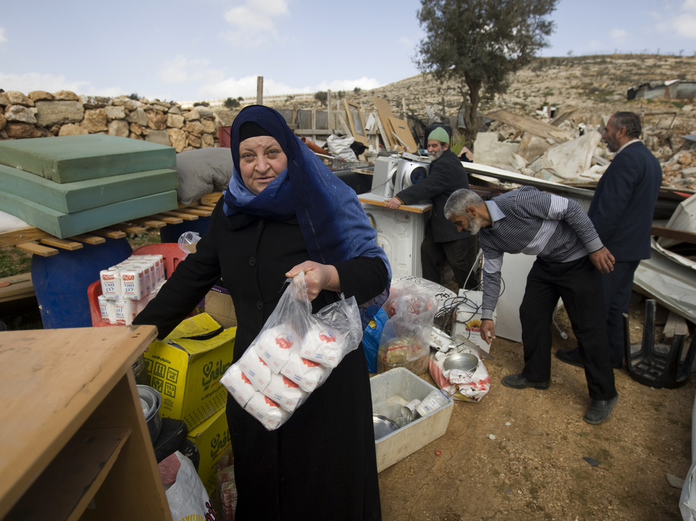 Palestinians collect their belongings after Israeli bulldozers raze their house in an Arab neighborhood in east Jerusalem on Feb. 9.