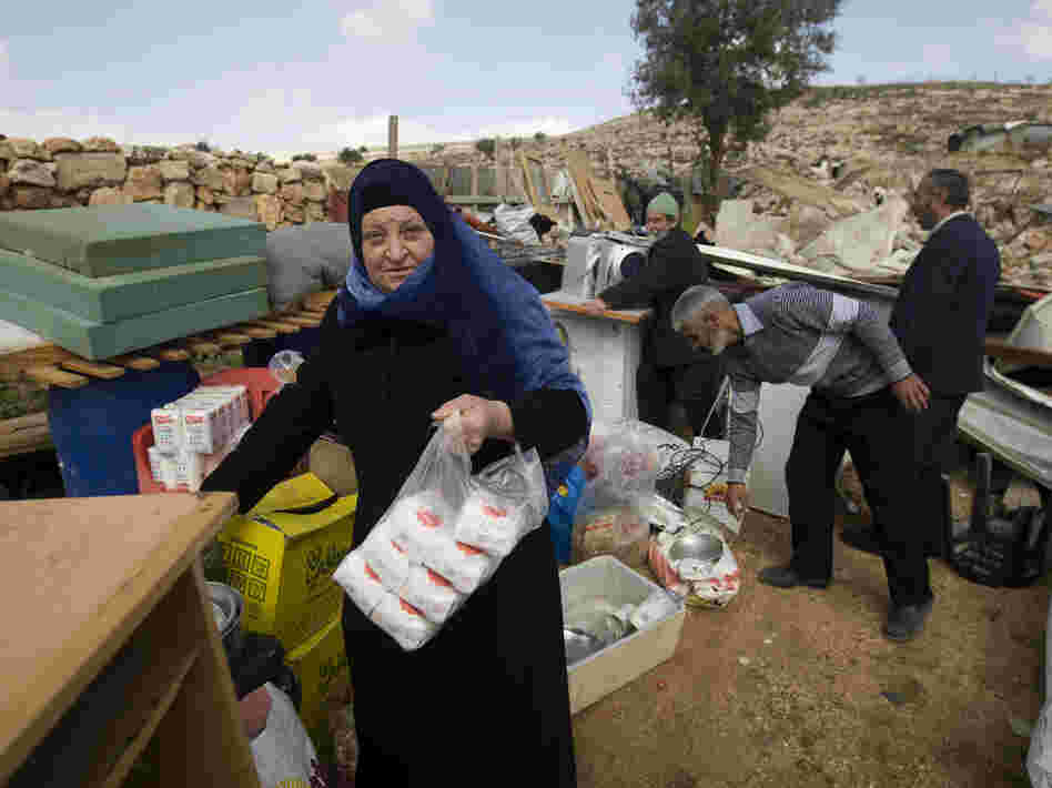 Palestinians collect their belongings after Israeli bulldozers raze their house in an Arab neighborhood in east Jerusalem on Feb. 9.