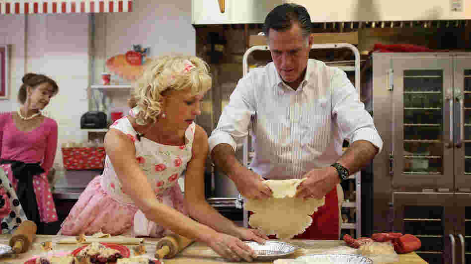 Republican presidential candidate Mitt Romney makes a pie shell with store owner Linda Hundt during a campaign stop Tuesday in DeWitt, Mich.