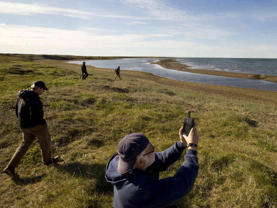Richard E. Reanier, an independent archaeologist working for Shell Oil, uses GPS to record the location of the remains of a sod house along the Chukchi Sea coast near Wainwright, Alaska, in July 2011.