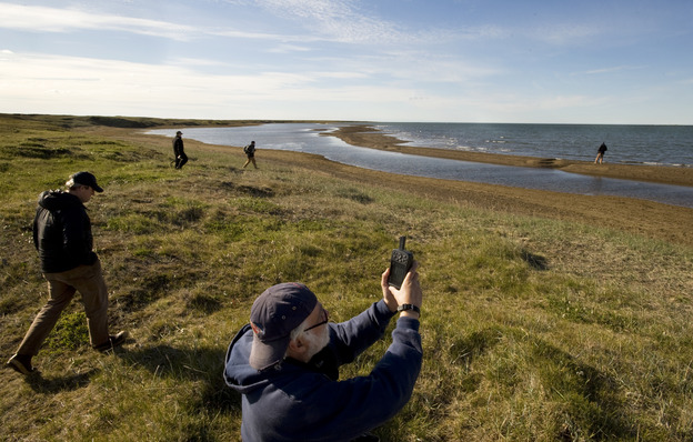 Richard E. Reanier, an independent archaeologist working for Shell Oil, uses GPS to record the location of the remains of a sod house along the Chukchi Sea coast near Wainwright, Alaska, in July 2011.
