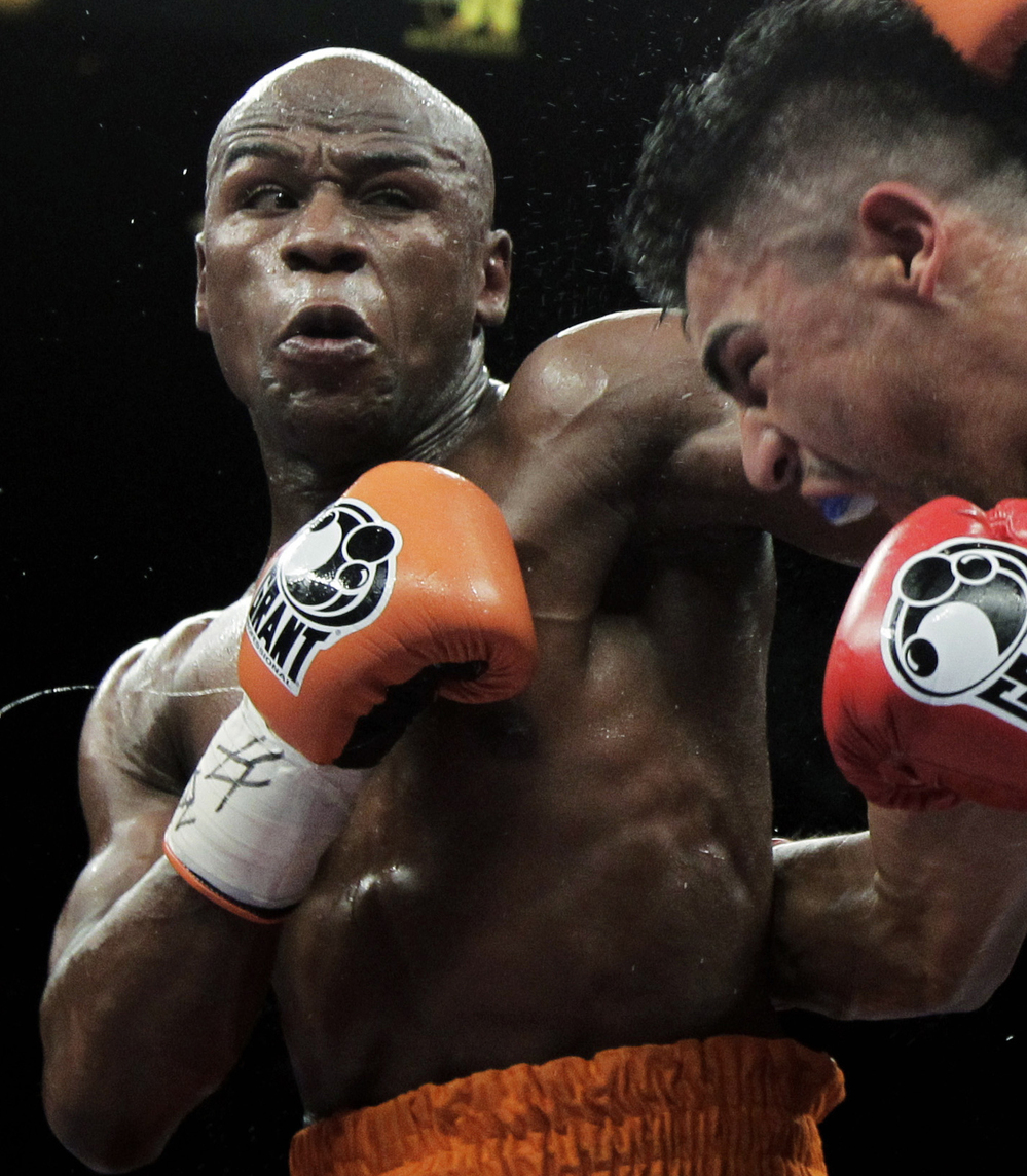 Floyd Mayweather Jr., left, punching Victor Ortiz during their WBC welterweight title fight in Las Vegas in September.