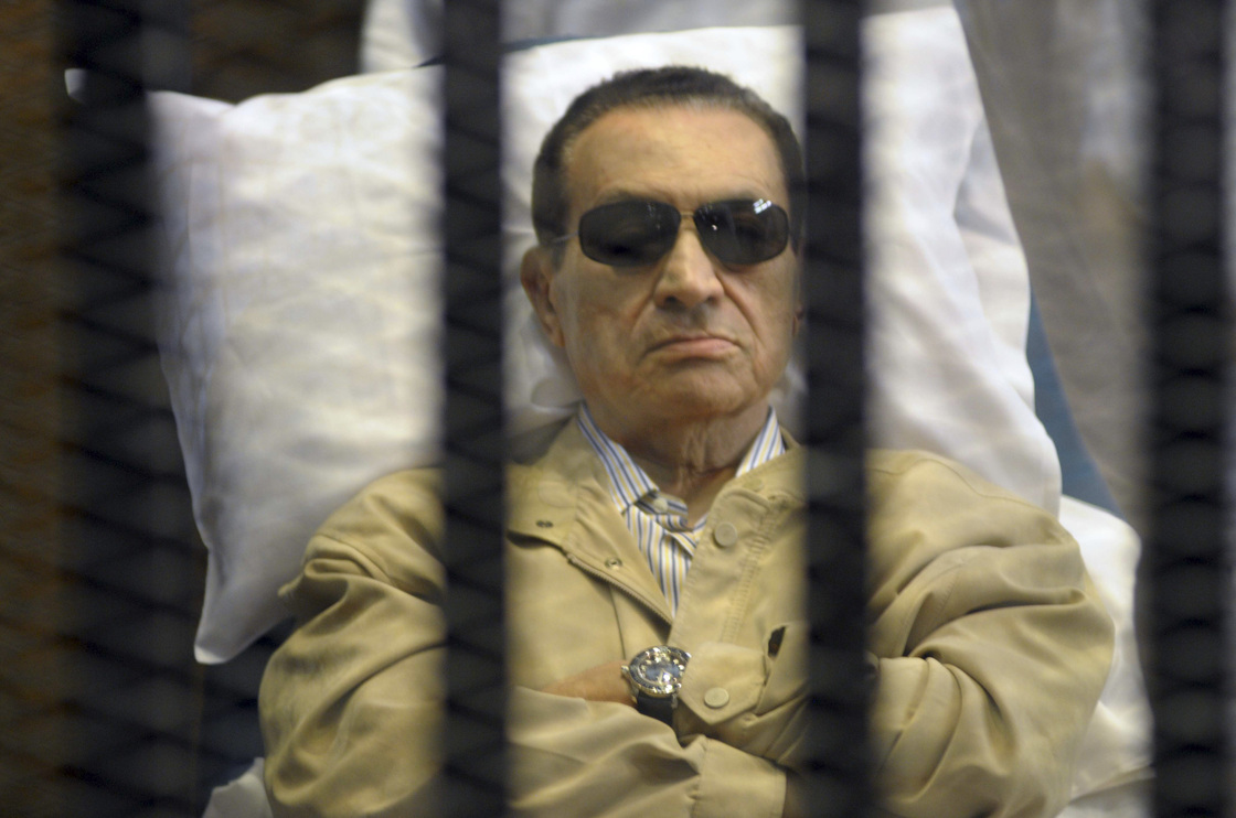 Egypt's ex-President Hosni Mubarak lays on a gurney inside a barred cage in the police academy courthouse in Cairo, Egypt during his sentencing in June.