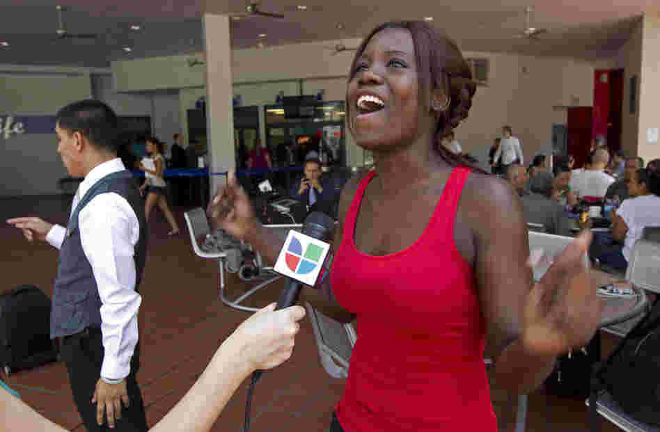 Niouseline St. Jean, originally from Turks and Caicos Islands who lives in the U.S. illegally, reacts as she talks to the media about the new immigration ruling for students at the Miami Dade Community College in Miami last Friday.