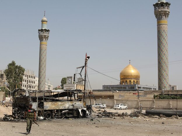 A suicide car bombing destroyed this bus outside a Shiite holy shrine in a Damascus, Syria, suburb on June 14. More than a dozen people were hurt in this attack as the violence nationwide continues to escalate.
