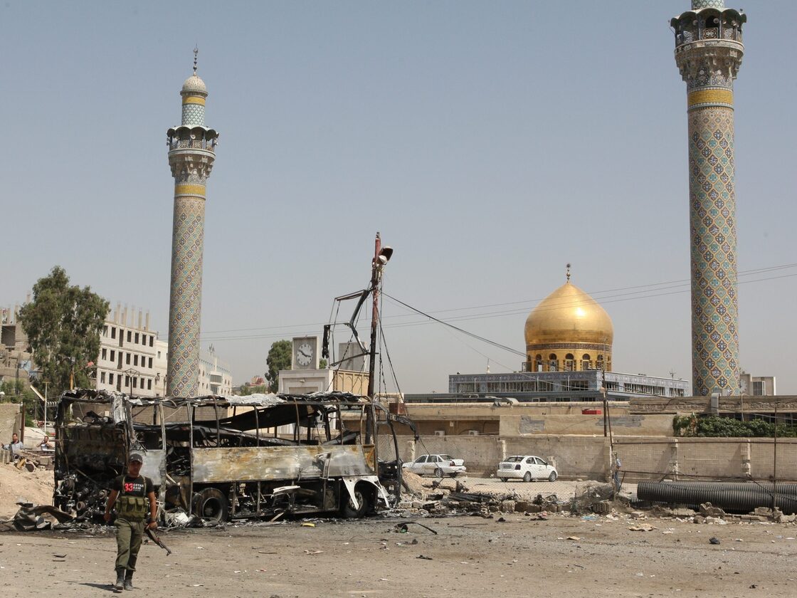 A suicide car bombing destroyed this bus outside a Shiite holy shrine in a Damascus, Syria, suburb on June 14. More than a dozen people were hurt in this attack as the violence nationwide continues to escalate.