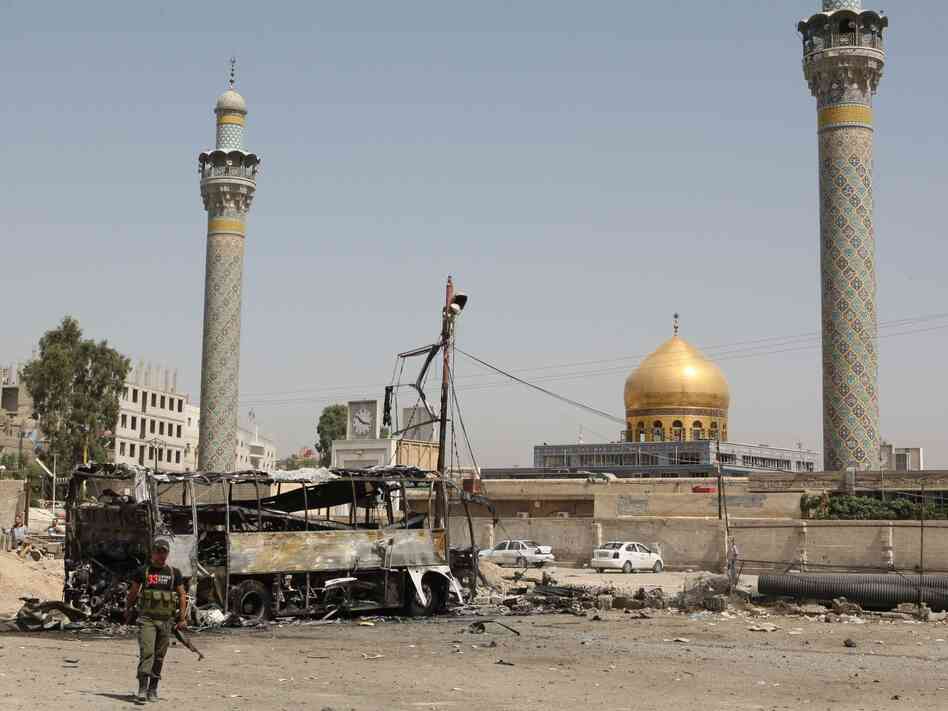 A suicide car bombing destroyed this bus outside a Shiite holy shrine in a Damascus, Syria, suburb on June 14. More than a dozen people were hurt in this attack as the violence nationwide continues to escalate.
