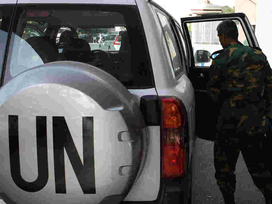 The United Nations observer team in Syria suspended its mission last Saturday, June 16, after facing repeated dangers and difficulties in trying to do its work. One observer is shown here next to a U.N. vehicle outside a hotel in Damascus.