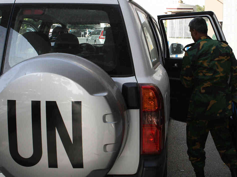 The United Nations observer team in Syria suspended its mission last Saturday, June 16, after facing repeated dangers and difficulties in trying to do its work. One observer is shown here next to a U.N. vehicle outside a hotel in Damascus.