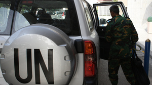 The United Nations observer team in Syria suspended its mission last Saturday, June 16, after facing repeated dangers and difficulties in trying to do its work. One observer is shown here next to a U.N. vehicle outside a hotel in Damascus.