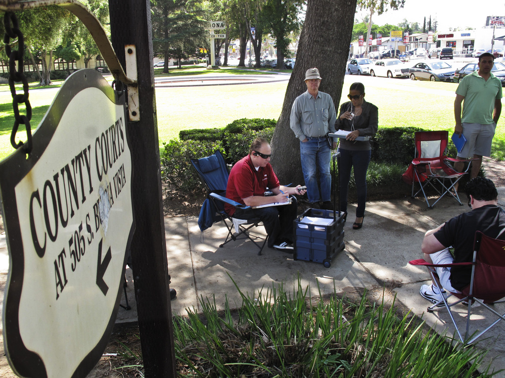 Daily auctions are held on foreclosed properties in front of the county courthouse in Corona, Calif. About 80 bidders, representing investors, show up to bid on properties.