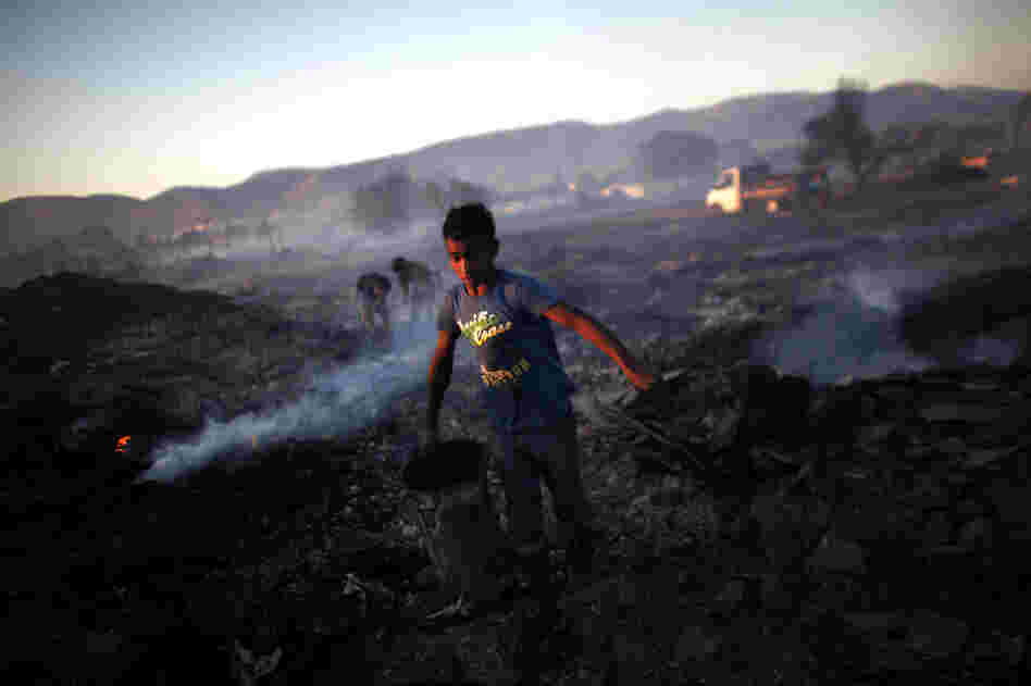 The fire broke out in the industrial zone of Athens in the early afternoon, threatening the Hellenic Airforce base and a Roma encampment. The fire broke out in the industrial zone of Athens in the early afternoon, threatening the Hellenic Airforce base and a Roma encampment.