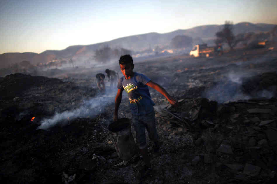 The fire broke out in the industrial zone of Athens in the early afternoon, threatening the Hellenic Airforce base and a Roma encampment. The fire broke out in the industrial zone of Athens in the early afternoon, threatening the Hellenic Airforce base and a Roma encampment.