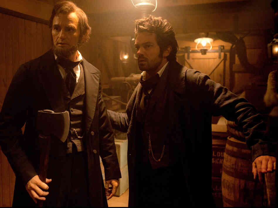 Abraham Lincoln with Henry Sturges (Dominic Cooper), a friendly member of the undead who trains Lincoln as a vampire hunter.