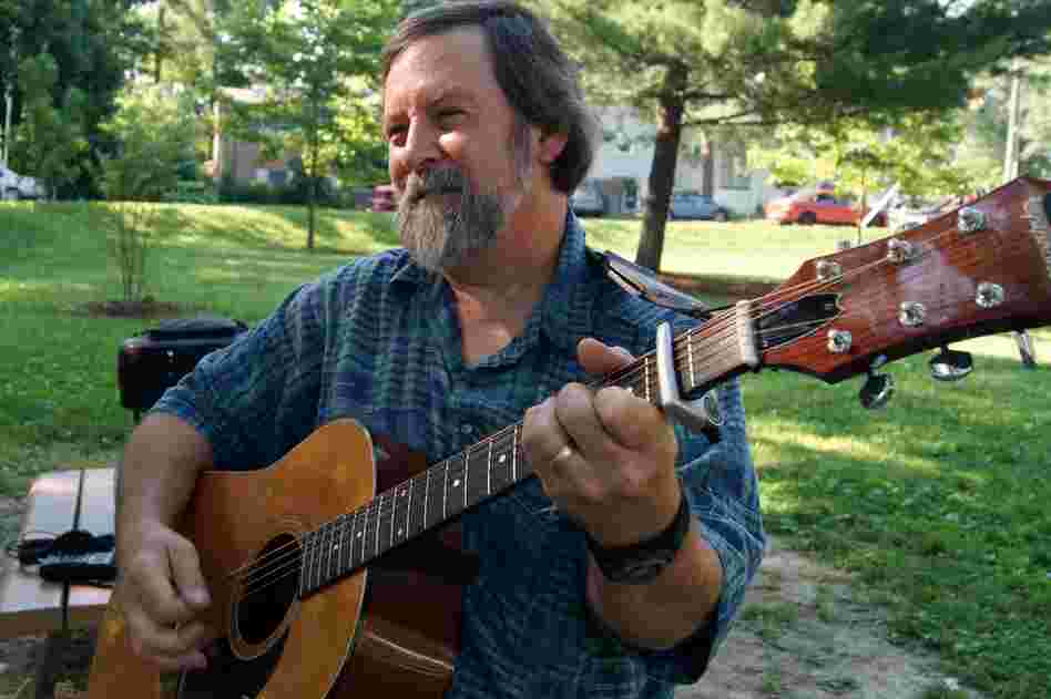 Bruce Day, the president of CABOMA, plays his acoustic guitar.