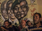 In Cairo's Tahrir Square on Tuesday night, men gathered in front of graffiti showing ousted President Hosni Mubarak and others from his regime. In Cairo's Tahrir Square on Tuesday night, men gathered in front of graffiti showing ousted President Hosni Mubarak and others from his regime.