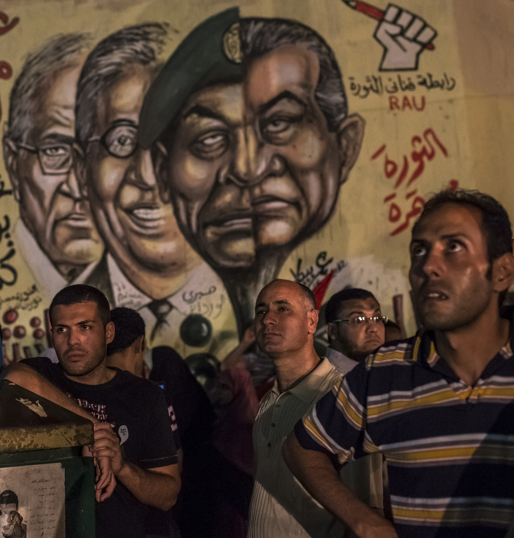 In Cairo's Tahrir Square on Tuesday night, men gathered in front of graffiti showing ousted President Hosni Mubarak and others from his regime.