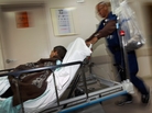 Wilfred Mobley pushes a patient to the X-ray room at the University of Miami Hospital on April 30 in Miami, Fla. Some experts say if the Affordable Care Act is overturned people who now have insurance will revert to a system where the emergency room is their first visit when sick. Wilfred Mobley pushes a patient to the X-ray room at the University of Miami Hospital on April 30 in Miami, Fla. Some experts say if the Affordable Care Act is overturned people who now have insurance will revert to a system where the emergency room is their first visit when sick.